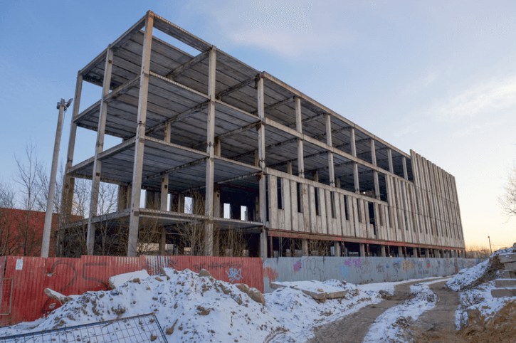 Brownfield project site with half-built, four-story building