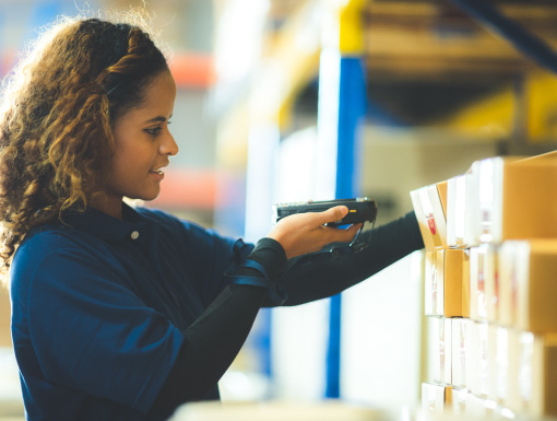 Woman scanning a labeled box with a RF device