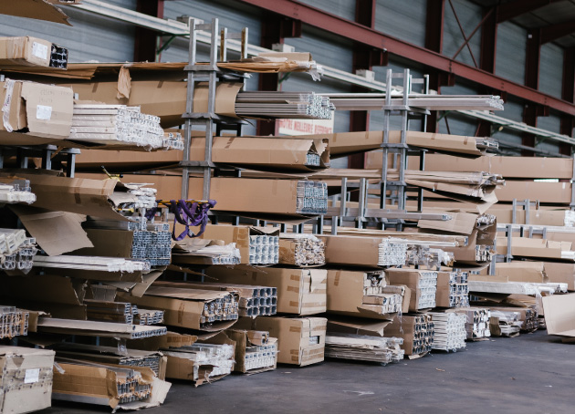 Metal racking in warehouse containing boxes of long metal material